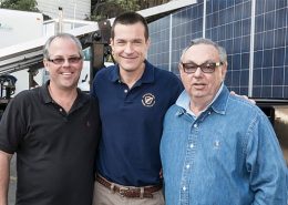 Jason Bateman on the movie set of "Bad Words", standing in front of a mobile solar trailer.