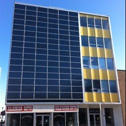 A total of 96 solar modules mounted on the front of a building in Anchorage, Alaska, generate solar power with three Sunny Boy 6000-US inverters.